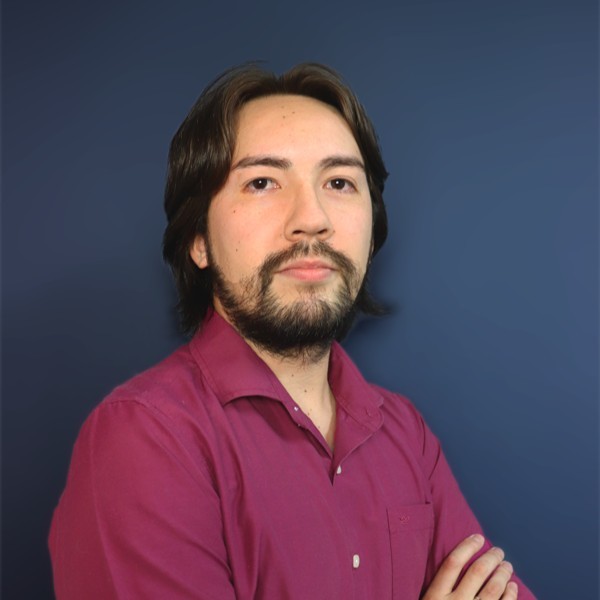 Shiogui Nagasse with his arms crossed wearing a suit